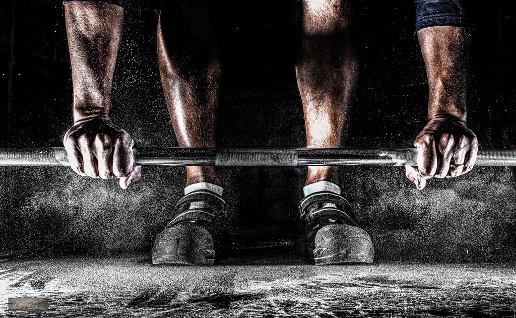 An athlete chalking up before a heavy deadlift