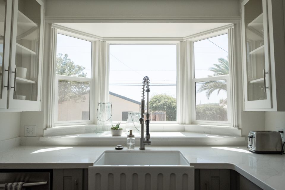 A bright kitchen with a freshly fitted sink and tap